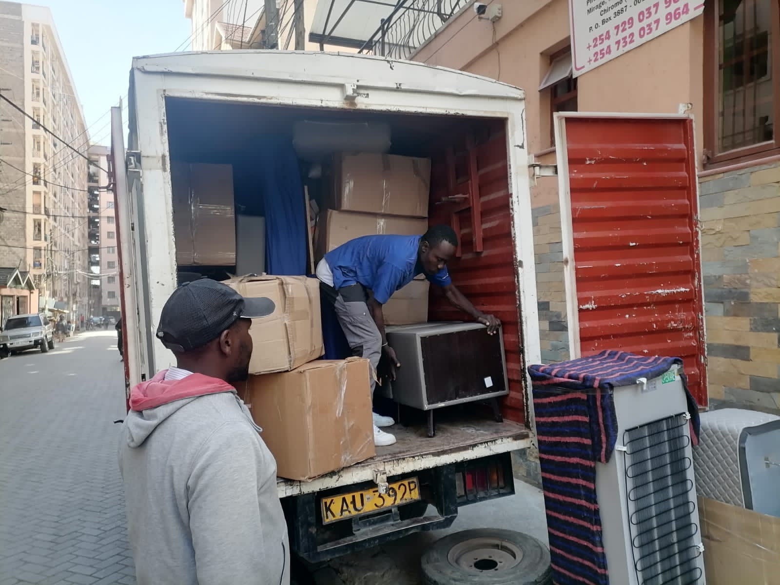 Professional movers carefully loading household furniture into a moving truck during a local move